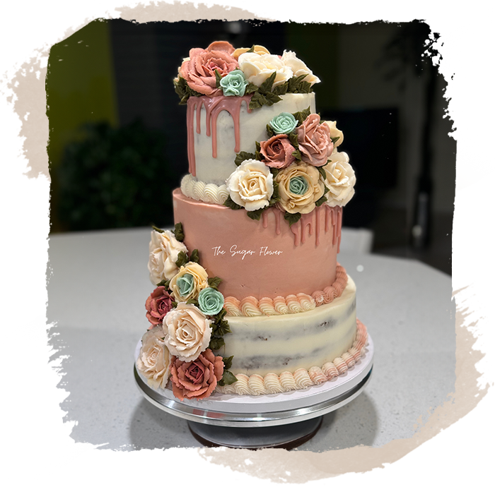 A three layer cake with flowers on top of it.